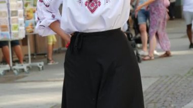 A beautiful female figure in an embroidered shirt, a Ukrainian national costume, an embroidered shirt and a black skirt.