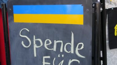 The inscription is in German, in translation it means a donation for Ukraine. Sign with a call to help Ukraine with an aggressive war with Russia.