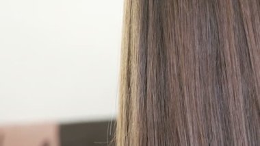 Close-up beautiful long dark brown hair of a young girl