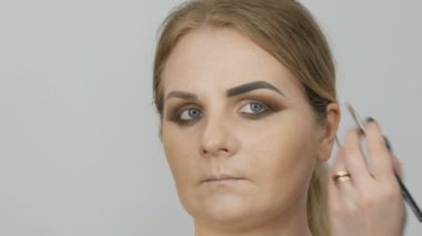 Professional yellow brown beige evening makeup smoky eyes. Eye makeup, face. Cosmetic concept