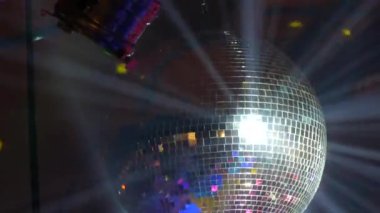 Bir partide ya da bir kutlamada gümüş ayna disko balosu. Kulüpteki doğum günü partisinde ışıklandırma tasarımı. Retro disko topunun soyut arkaplanı.