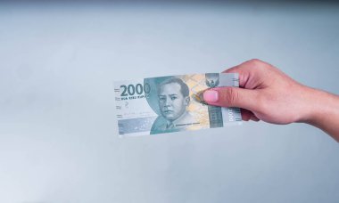 Zihin Bölümü Man Hand Endonezya 'ya seçici odak olarak 2000 Rupi verdi