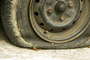 Close up of flat tire of an old rusty car