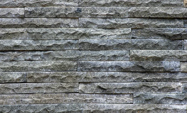 天然の暗い石畳の壁の背景 — ストック写真
