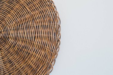 Round woven placemat isolated on a white background. Copy space.