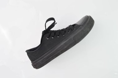 Beyaz arka planda siyah pamuklu ayakkabı izole edilmiş.