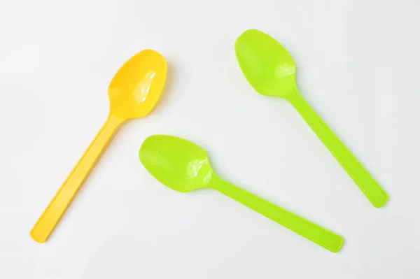 黄色和绿色的勺子隔离在白色的背景上 — 图库照片