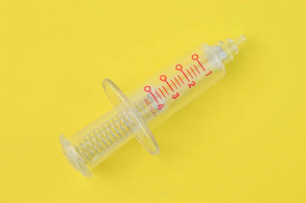 Medical Syringe Isolated Yellow Background — стоковое фото