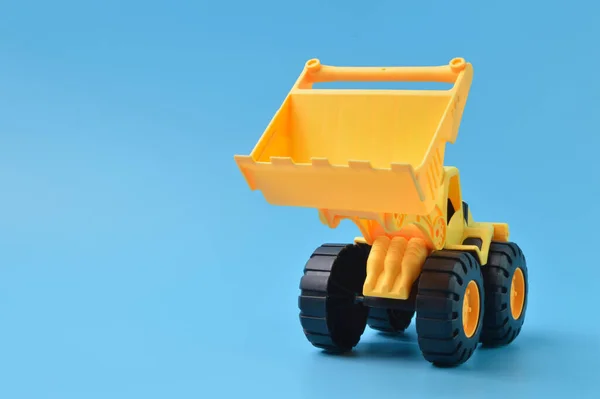 Construction Plastic Backhoe Tractor Toy Isolated Blue Background — ストック写真