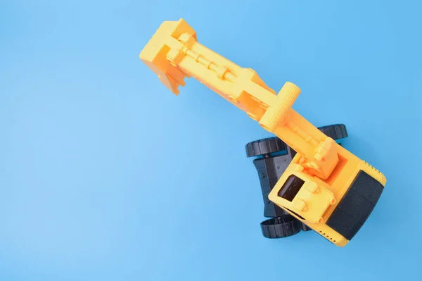 Construction Digger Tractor Toy Isolated Blue Background — ストック写真
