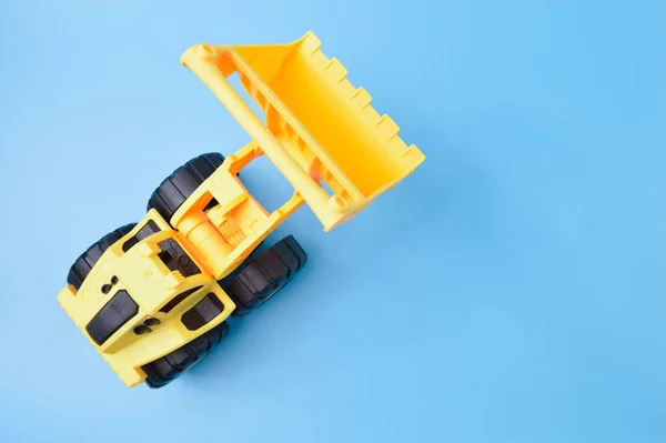 Construction Loader Tractor Toy Isolated Blue Background — ストック写真