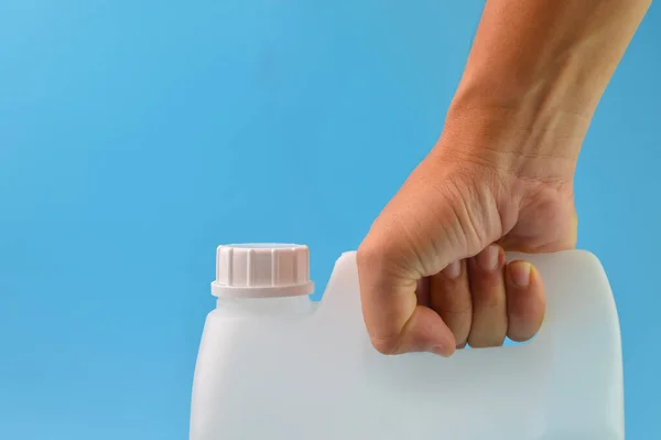 Hand Holding White Gallon Container Isolated Blue Background — Stock Photo, Image