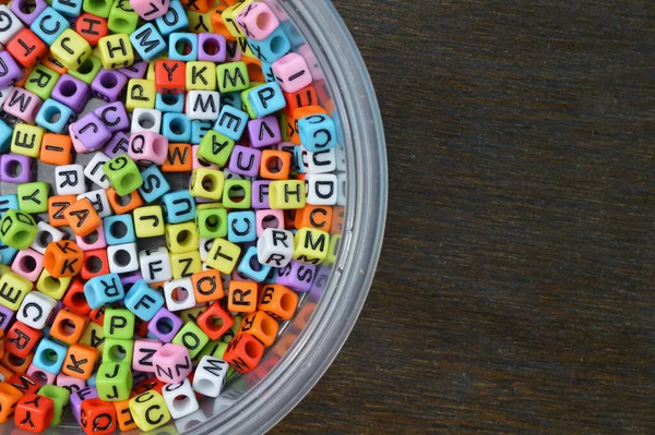 Colorful Alphabet Beads Plastic Bowl Copy Space Text — Foto Stock