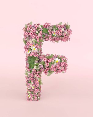 Creative letter F concept made of frash Spring wedding flowers. Flower font concept on pastel pink background.