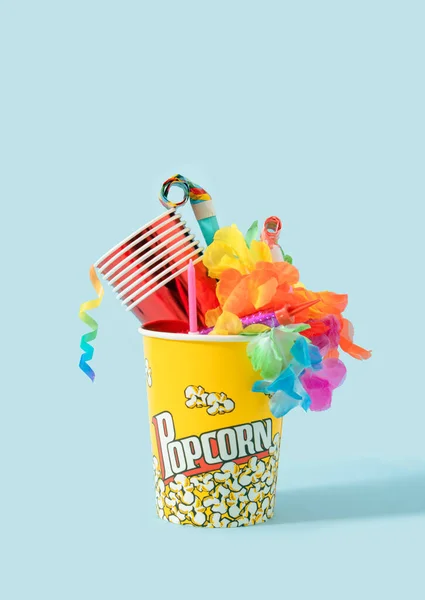 Creative Birthday party concept of caps, paper straws, candy, balloons  blowers and confetti. Colorful background.