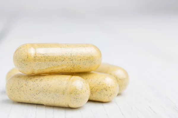 Yellow Herbal Capsules White Table Medication Treatment Alternative Medicine Close — Stock Photo, Image