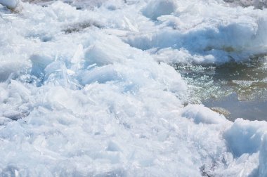 Blocks of ice on the river in spring. Needle texture. Sunny day.