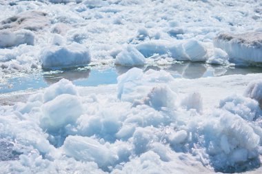 Blocks of ice on the river in spring. Needle texture. Sunny day.