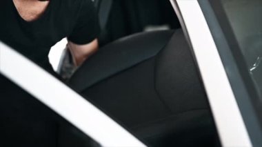 Araba yıkamada temizlikçiyim. Arabadan bir koltuğu indiriyorum. Yavaş çekim
