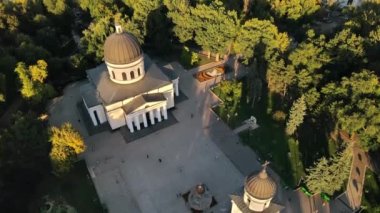 Chisinau 'nun gün batımında hava aracı görüntüsü. Central Park manzarası, Katedral, çan kulesi, bir sürü yeşillik, yürüyen insanlar. Moldova