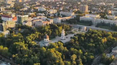 Chisinau 'nun gün batımında hava aracı görüntüsü. Central Park manzarası, Katedral, çan kulesi, bir sürü yeşillik, yürüyen insanlar, binalar, hükümet. Moldova