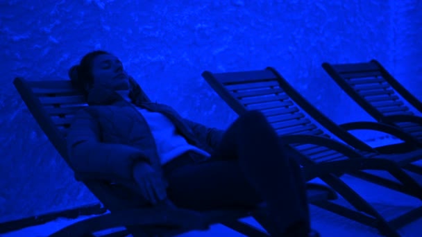 Woman Relaxing Wooden Chair Salt Room Blue Light — Stock Video