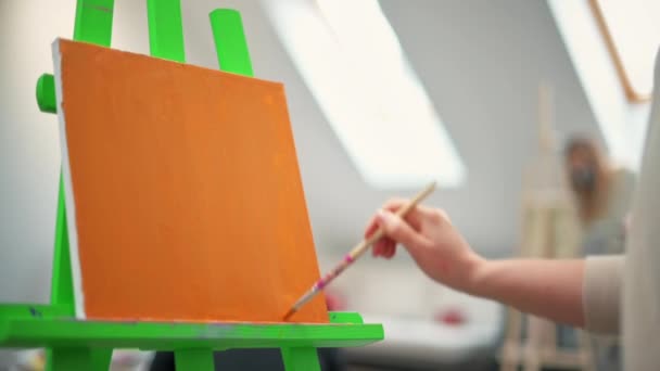 一个女人用画笔在画室里画一幅画 慢动作 — 图库视频影像