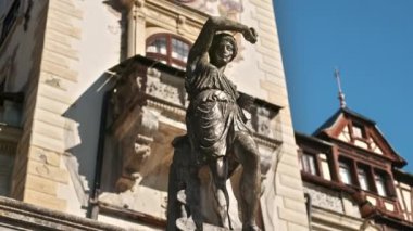 Romanya 'daki The Peles Castle' daki heykelin dikey görüntüsü. Arka planda Castle