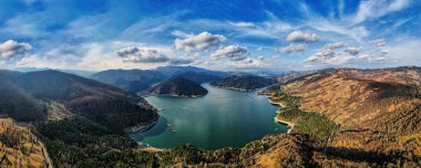 Romanya 'daki Bicaz Gölü' nün panoramik hava aracı görüntüsü. Karpat Dağları, yemyeşil ormanlarla kaplı tepeler
