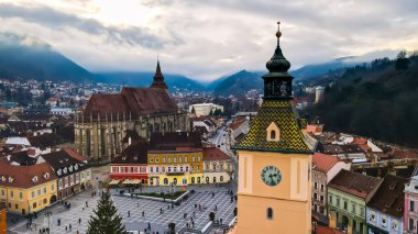 Romanya 'nın Brasov kentindeki Konsey Meydanı' nın insansız hava aracı görüntüsü. Noel için dekore edilmiş eski şehir merkezi. İlçe Tarih Müzesi, binalar, insanlar