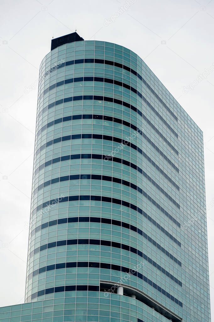 A modern building in Bucharest, Romania. Glass facade, cloudy sky