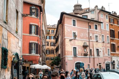 ROME, ITALY - JUNE, 2022: Square with buildings made in classic style and multiple walking people