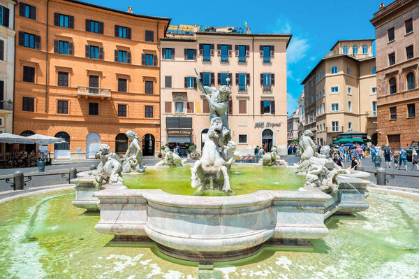 ROME, ITALY - JUNE, 2022: Fountain of Neptune located on the Piazza Navona with multiple tourists and classic buildings around it