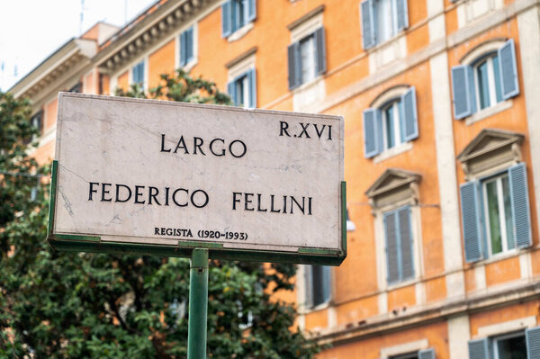 ROME, ITALY - JUNE, 2022: Street sign with Federico Fellini name on it