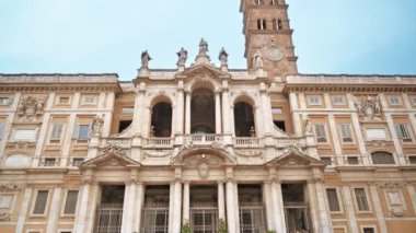 An old building made in classic style with sculptures and painted facade in Rome, Italy