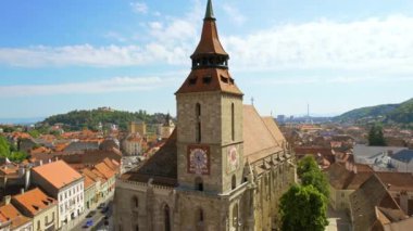 Aerial drone view of Brasov, Romania. Old city centre with Museum of History, Black church, buildings, people