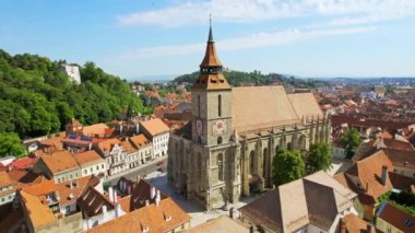 Aerial drone view of Brasov, Romania. Old city centre with Museum of History, Black church, buildings, people