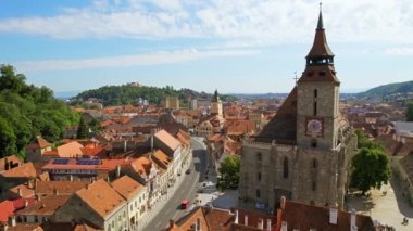 Aerial drone view of Brasov, Romania. Old city centre with Museum of History, Black church, buildings, people