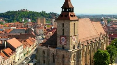Aerial drone view of Brasov, Romania. Old city centre with Museum of History, Black church, buildings, people