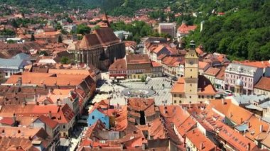 Aerial drone view of Brasov, Romania. Old city centre with Museum of History, Black church, buildings, people