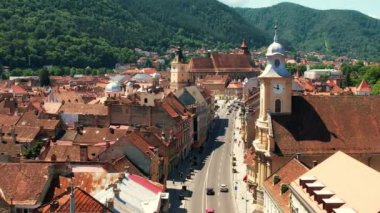 BRASOV, ROMANIA - JUNE, 2022: Aerial drone view of The Council Square in Brasov, Romania. Old city centre with County Museum of History, Black church, buildings, people