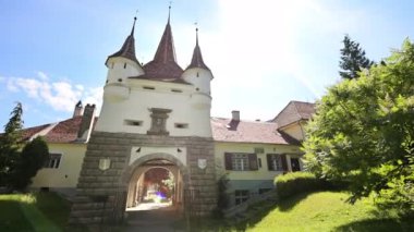 View of The Catherine's Gate in Brasov, Romania. A lot of greenery in front of it