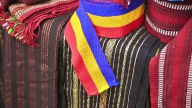 Close view of fabric tapes on the counter made in the form of a national moldavian flag and other national styles