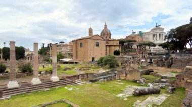 View of the Roman Forum in Rome, Italy. Ancient excavations with old buildings on the background, walking people. Slow motion