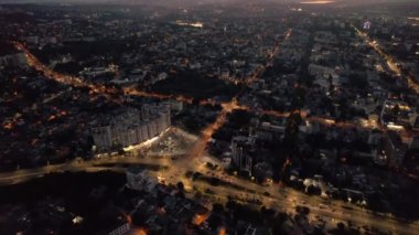 Aerial drone view of Chisinau downtown at sunset. Roads with moving cars and illumination. Moldova