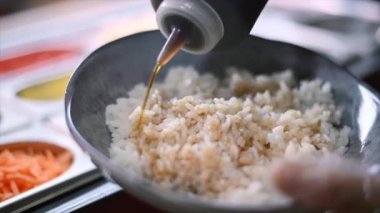 Cook making poke. Filling the rice with sauce in a bowl. Slow motion