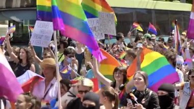 CHISINAU, MOLDOVA - JUNE, 2022: Lots of people at the gay pride parade in the city center. Multiple rainbow flags and posters. Slow motion