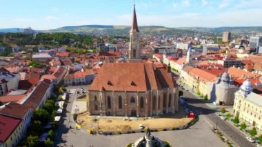 Aerial drone view of Saint Michael Church in Cluj, Romania. Cityscape, central square, old buildings, cars