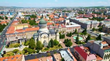 Aerial drone view of The Orthodox Cathedral located on the Avram Iancu Square in the centre of Cluj Napoca, Romania. Cityscape, central square, old buildings, cars