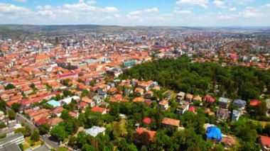 Aerial drone view of Cluj centre, Romania. Cityscape, roads with cars, old buildings, greenery